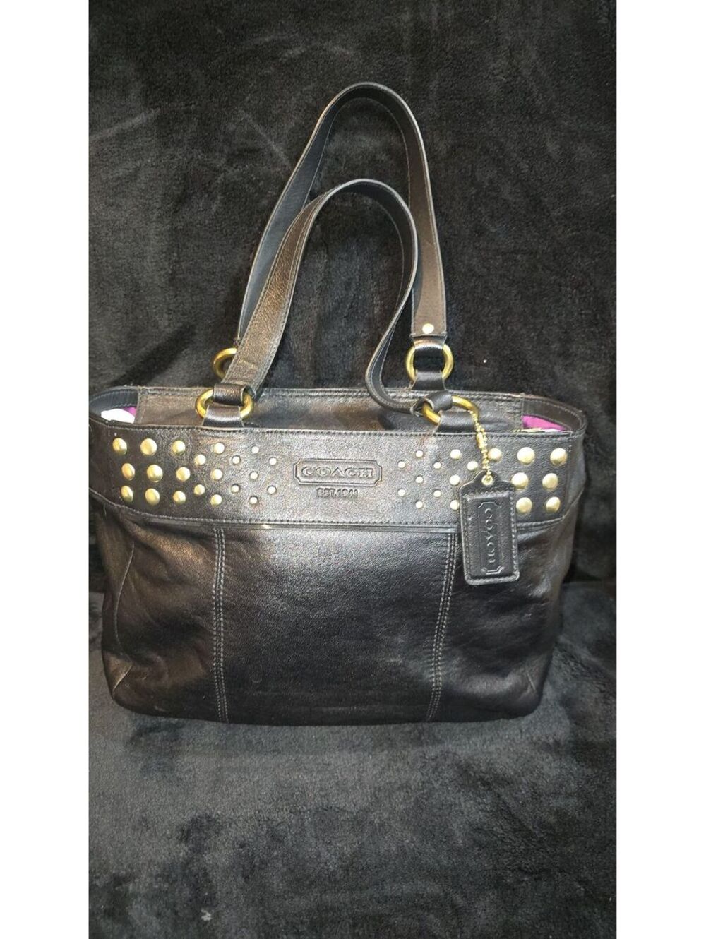 25. Coach 2009 East West Black Leather Gold Studded Tote